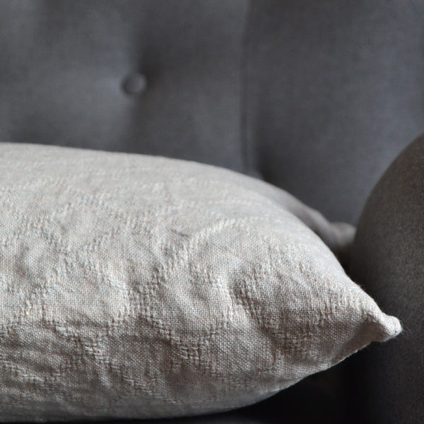 linen cushion cover with woven pattern of lace